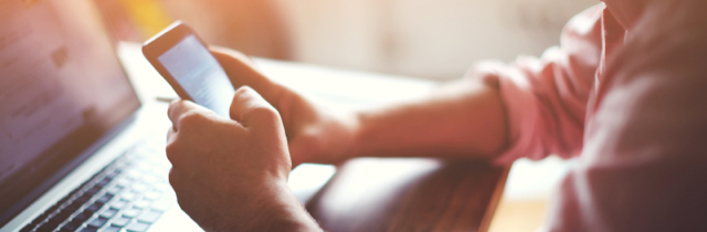 Man researching the differences between secured debt and unsecured debt on his cell phone